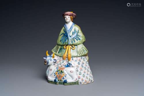 A polychrome Dutch Delft table bell in the shape of a lady o...