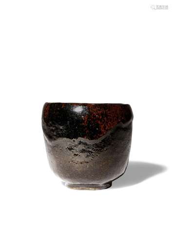 A JAPANESE BLACK RAKU WARE CHAWAN (TEA BOWL)