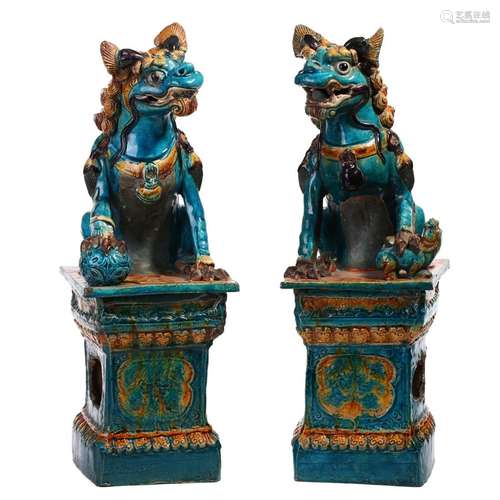 A PAIR OF POLYCHROME GLAZED PORCELAIN LIONS