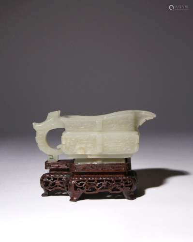 A CHINESE CELADON JADE ARCHAISTIC POURING VESSEL, YI