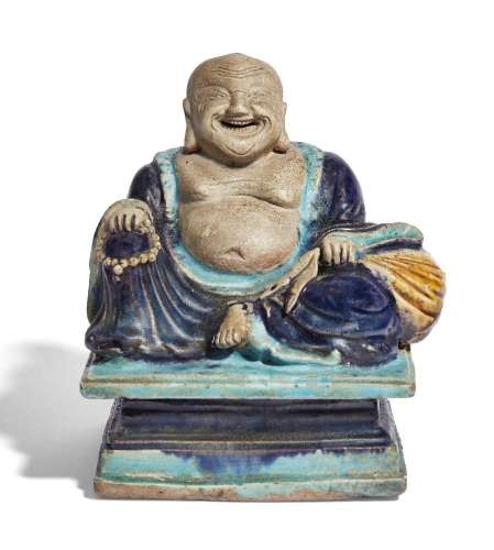 A Chinese Fahua figure of Budai, late Ming dynasty, modelled...