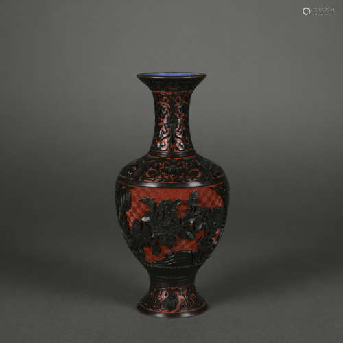 A carved red lacquer vase