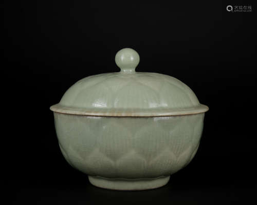 A celadon-glazed jar and cover