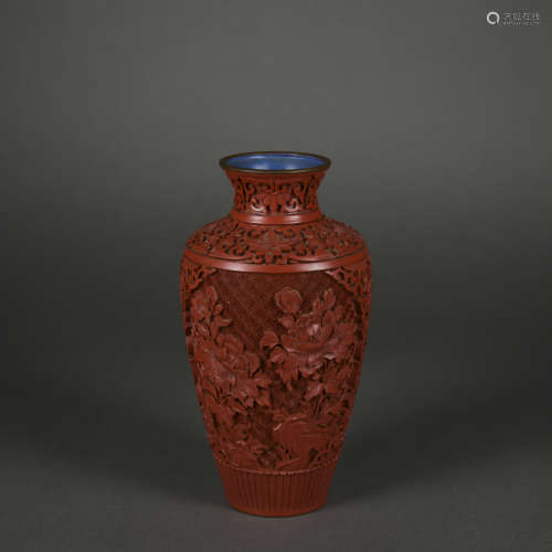 A carved red lacquer vase