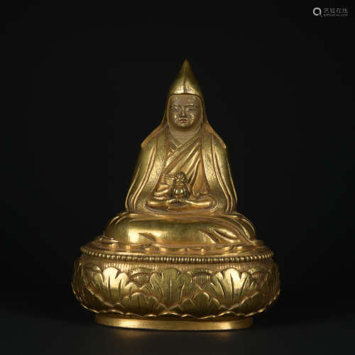 A gilt-bronze statue of Guru Buddha
