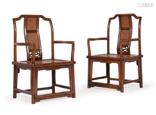 A pair of Chinese elm yoke back armchairs