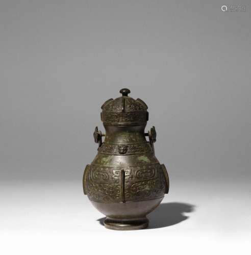 A CHINESE ARCHAISTIC WINE VESSEL AND COVER, YOU