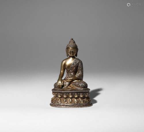 A PARCEL-GILT AND SILVERED COPPER FIGURE OF BUDDHA