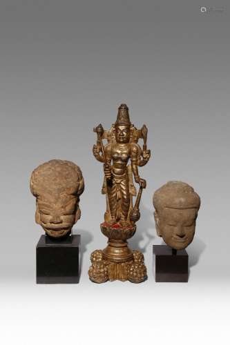 AN INDIAN LACQUERED AND GILT-WOOD FIGURE OF VISHNU AND TWO S...