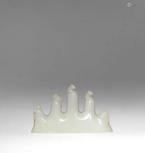 A CHINESE PALE CELADON JADE 'MOUNTAIN' BRUSH REST