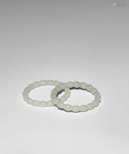A PAIR OF CHINESE PALE CELADON JADE BANGLES