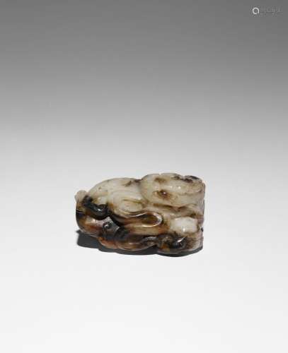 A CHINESE BLACK AND WHITE JADE CARVING OF A LION DOG