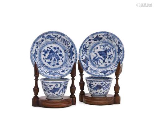 A pair of Chinese blue and white fish tea bowls and saucers