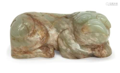 A Chinese green and russet jade carving of a lion
