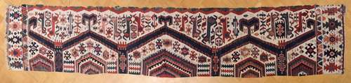 Konya kilim with hexagons and hooked outlines on a white fie...