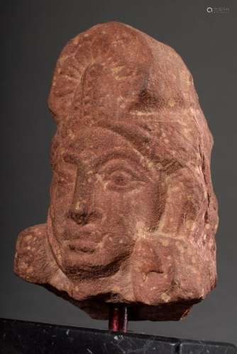 Red sandstone fragment "head" cut out of a relief ...