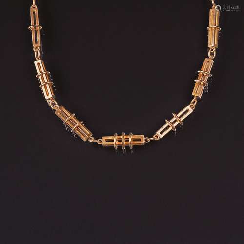 A long Gold Necklace.