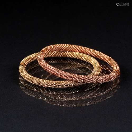 A Pair of bicolour Gold Bangle Bracelets.