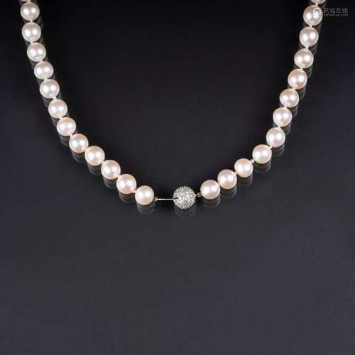 A long Pearl Necklace with Diamond Clasp.