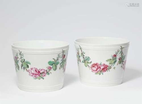 A pair of Berlin KPM porcelain cachepots with rose garlands