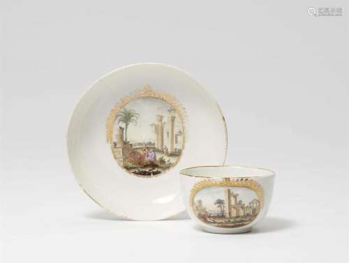 A German porcelain cup and saucer with Oriental landscapes