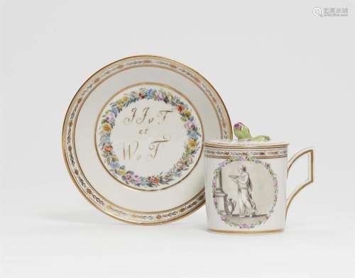 A Gotha porcelain cup and saucer with gilt monograms