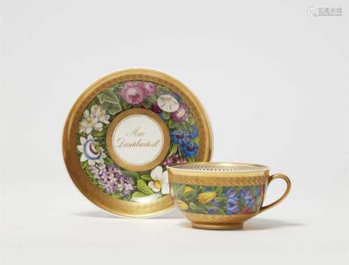 A large Berlin KPM porcelain cup and saucer with floral deco...