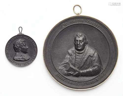 Two cast iron commemorative medallions