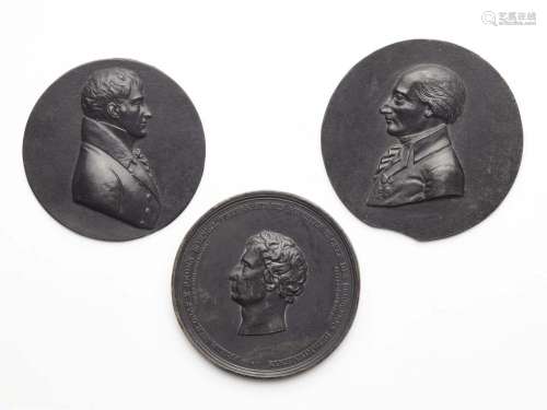 Two cast iron portrait plaques and a medallion
