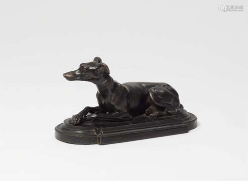 A cast iron paperweight with a greyhound