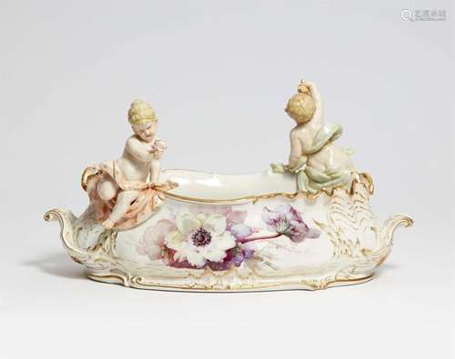 A rare Berlin KPM porcelain jardinière with a putto