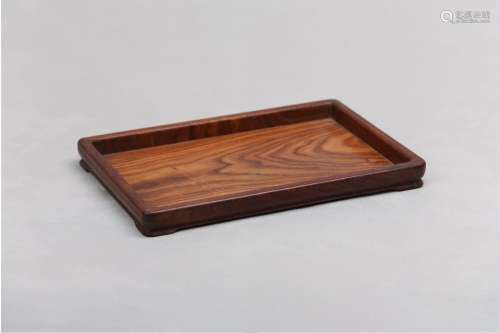 A CHINESE HUANGHUALI WOOD TRAY. The rectangular shallow tray...