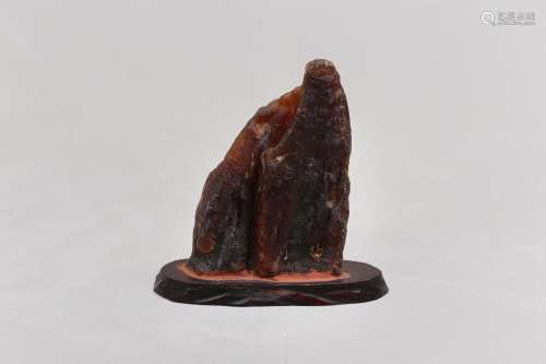 A CHINESE AMBER 'SCHOLAR'S ROCK' CARVING. Formed as a mounta...