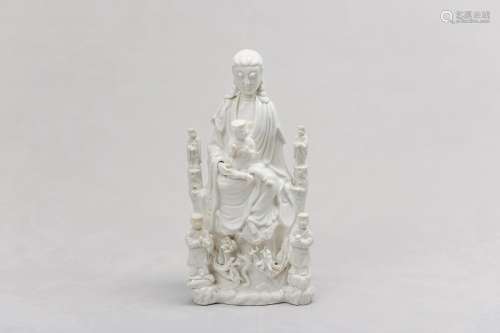 A CHINESE BLANC-DE-CHINE 'GUANYIN AND CHILD' GROUP. Qing Dyn...