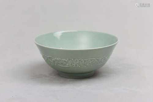 A CHINESE CELADON-GLAZED MOULDED BOWL. Qing Dynasty