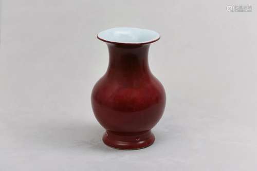 A CHINESE RED-GLAZED VASE. The ovoid body rising from a wide...