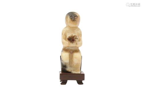 A CHINESE BLACK JADE CARVING OF A FIGURE. Song to Ming Dynas...