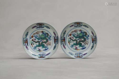 A PAIR OF CHINESE DOUCAI 'DRAGON' SAUCER DISHES. Qing Dynast...