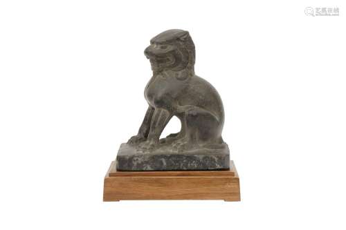 A CHINESE STONE FIGURE OF A LION DOG. Seated on its haunces ...