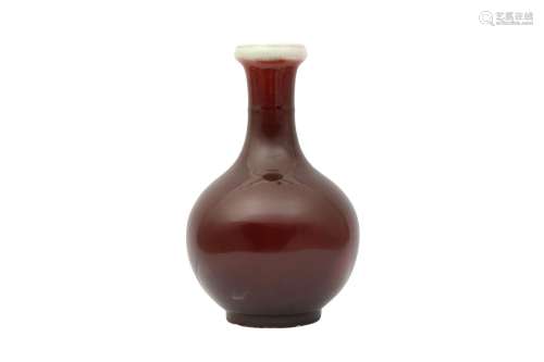 A CHINESE SANG DE BOEUF-GLAZED BOTTLE VASE. The bulbous body...