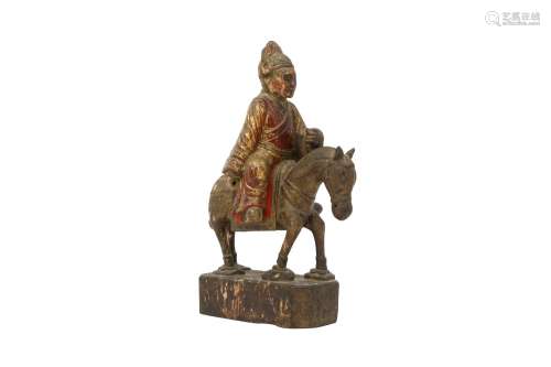 A CHINESE GILT-LACQUER WOOD FIGURE OF A HORSERIDER. Depictin...