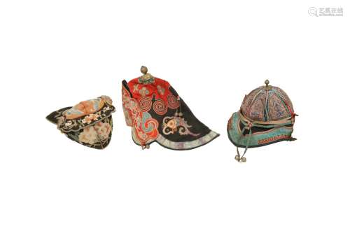THREE CHINESE EMBROIDERED HATS. Qing Dynasty. The first work...
