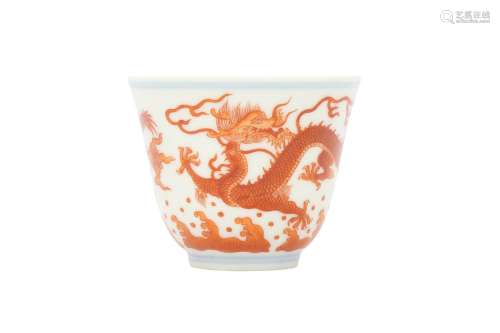 A SMALL CHINESE IRON-RED 'DRAGON' CUP. The tall flared sides...
