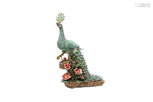 A CHINESE FAMILLE ROSE MODEL OF A PEACOCK. The large bird lo...