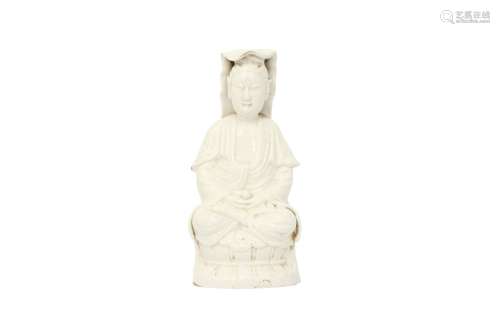 A CHINESE BLANC-DE-CHINE FIGURE OF GUANYIN. Seated on a lotu...
