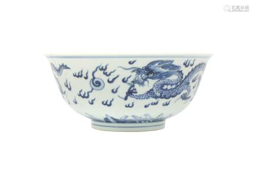 A CHINESE BLUE AND WHITE 'DRAGON' BOWL. Rising from a tapere...