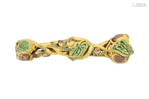 A CHINESE FAMILLE VERTE 'FRUIT' RUYI SCEPTRE. Formed as fing...