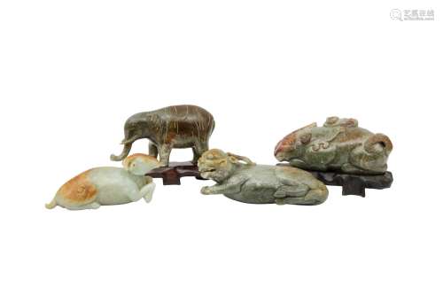 FOUR CHINESE CELADON JADE ANIMAL CARVINGS. Including: an ele...