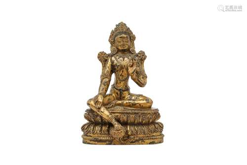 A SINO-TIBETAN GILT-BRONZE FIGURE OF A GREEN TARA. Seated in...