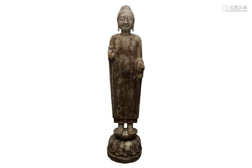 A CHINESE STONE CARVING OF A STANDING BUDDHA. The robed figu...